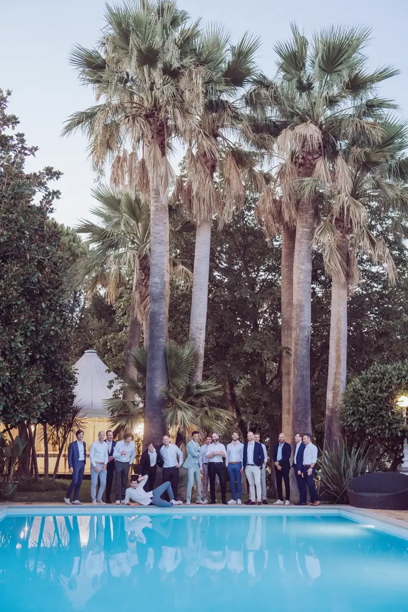 Bräutigam steht mit seinen Jungs am Pool und alle posen