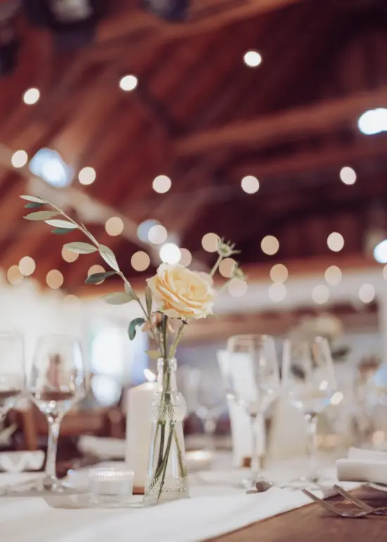 Tischdeko mit Blume und Bokehkreisen im Hintergrund